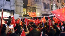 Supporters of Turkey's President Recep Tayyip Erdogan wave flags outside the Dutch consulate during a protest, in Istanbul, early Sunday, March 12, 2017.