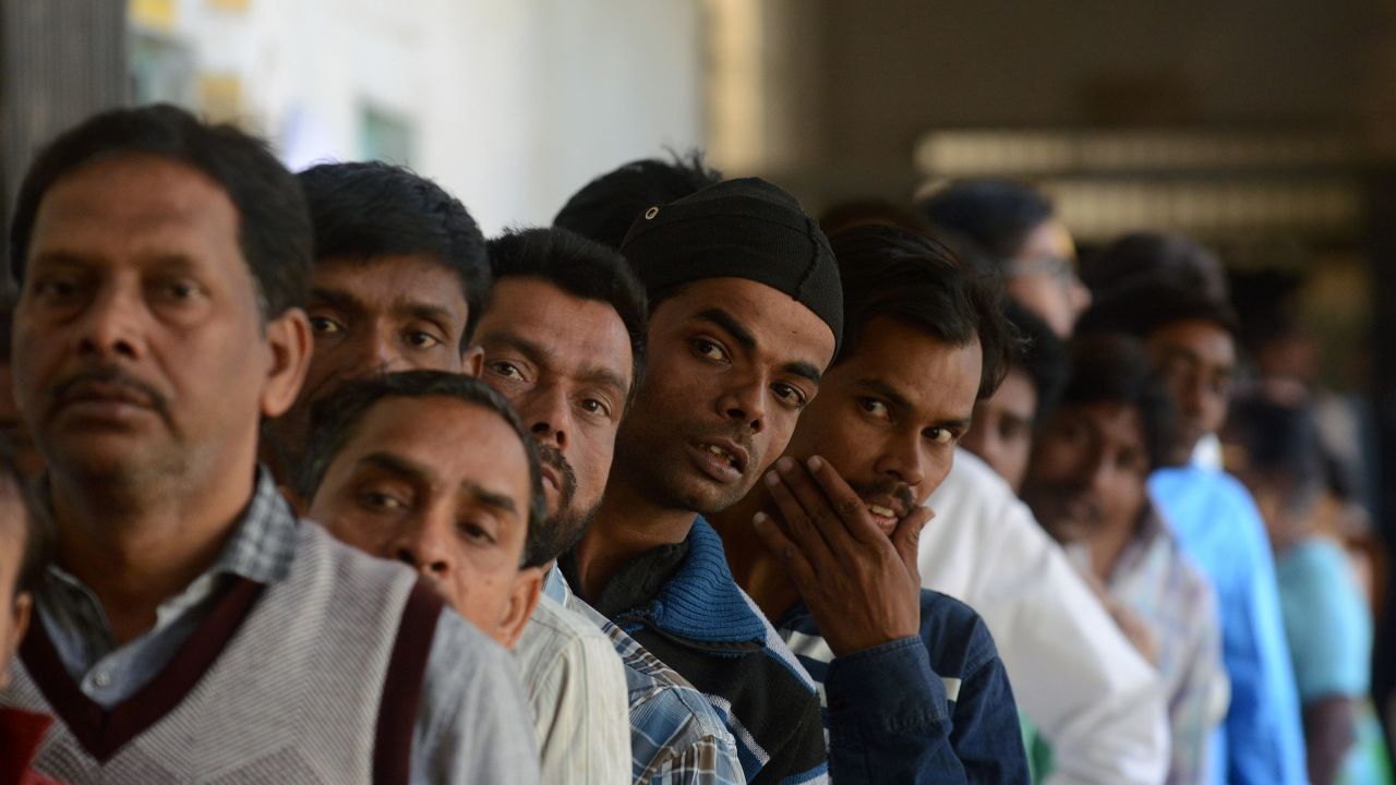 Indian voters wait in line at a polling station in the Naini area on the outskirts of Allahabad during the fourth phase of Uttar Pradesh state assembly elections on February 23.