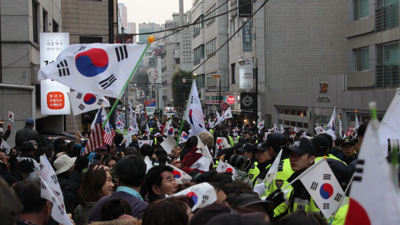 Supporters of impeached South Korean President Park Geun-hye gather outside her house Sunday in Seoul's Gangnam district. 