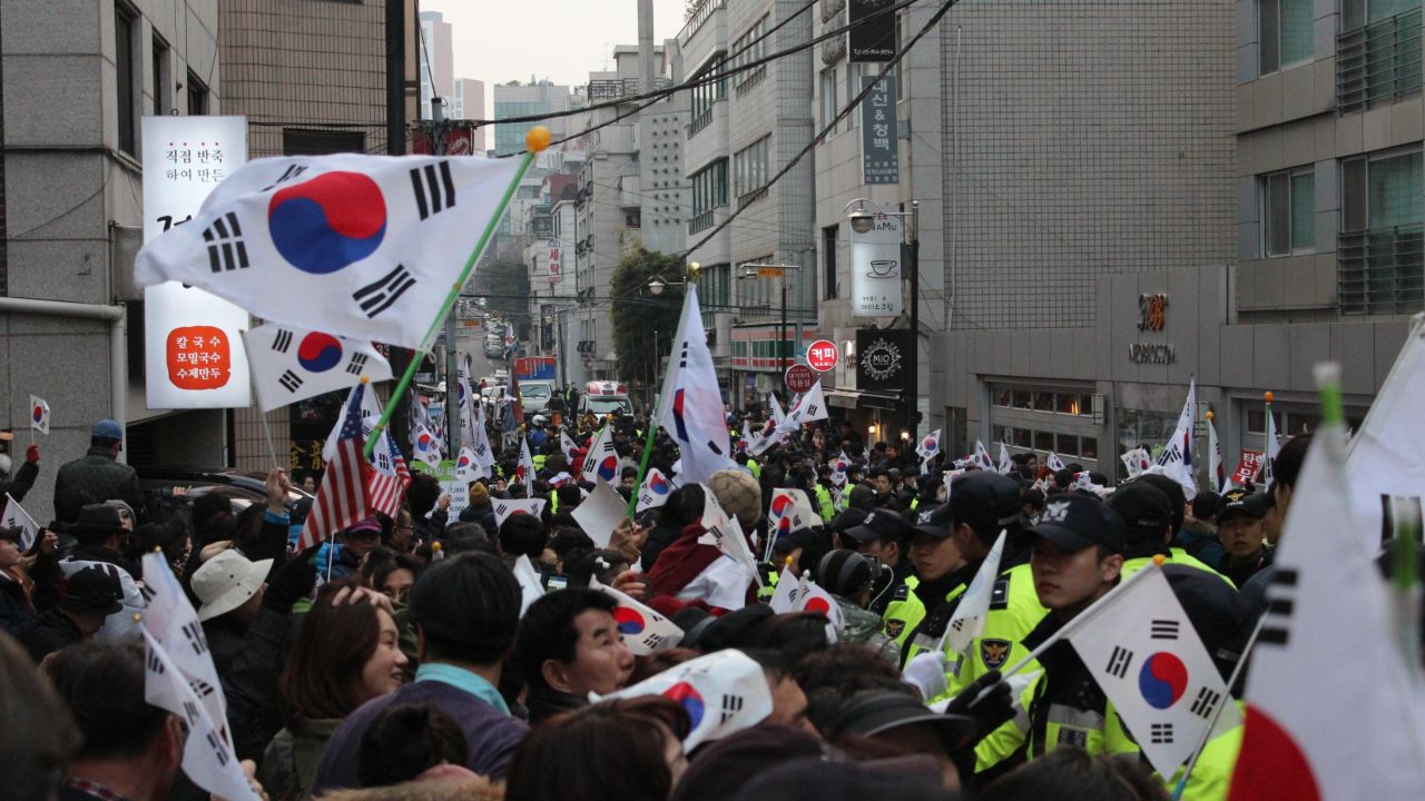 Supporters of impeached South Korean President Park Geun-hye gather outside her house Sunday in Seoul's Gangnam district.