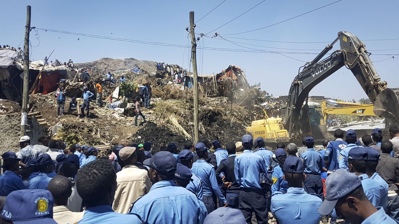 Police officers secure the scene after the landslide at the landfill, as excavators aid rescue efforts on the outskirts of Addis Ababa on Sunday, March 12, 2017.