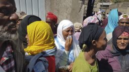 Residents grieve after more bodies are recovered at the landfill Sunday.