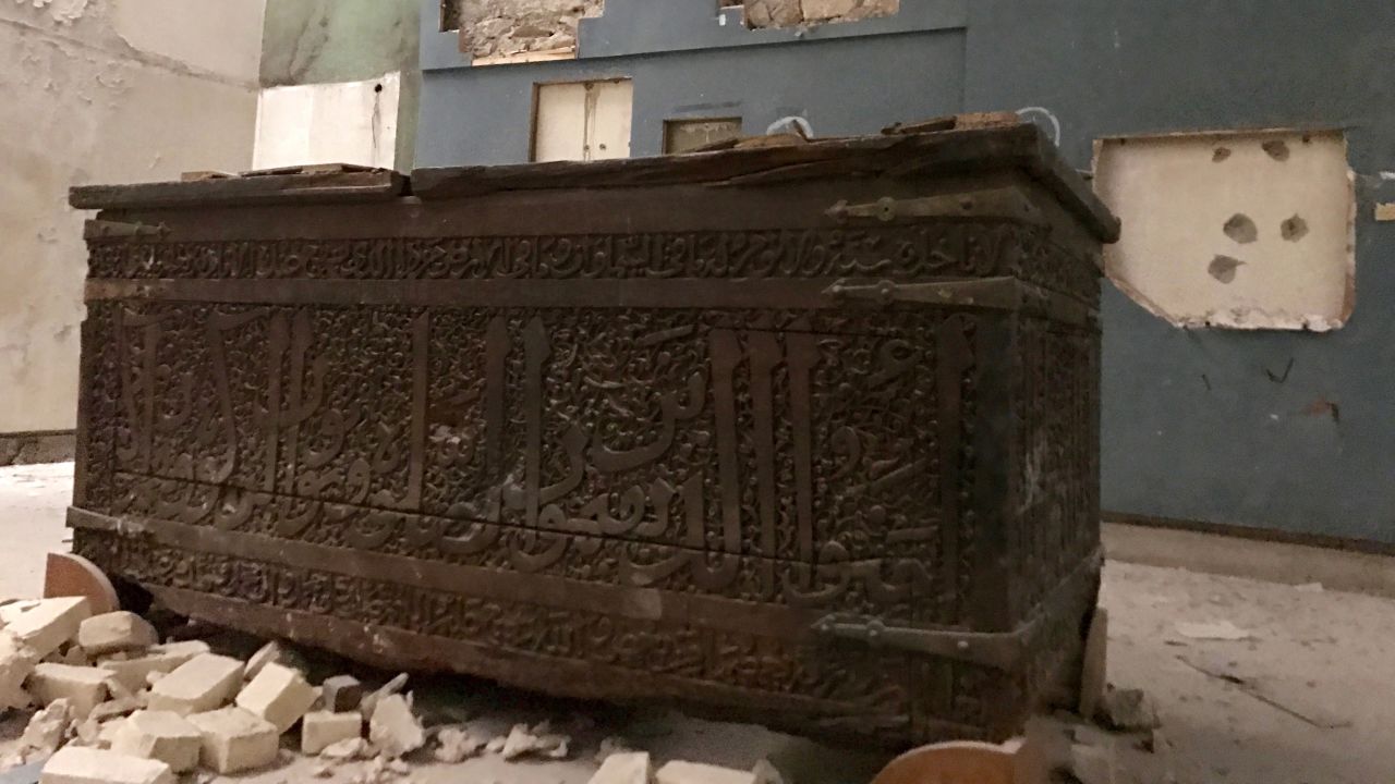 An old wooden chest with Arabic writings on it. 