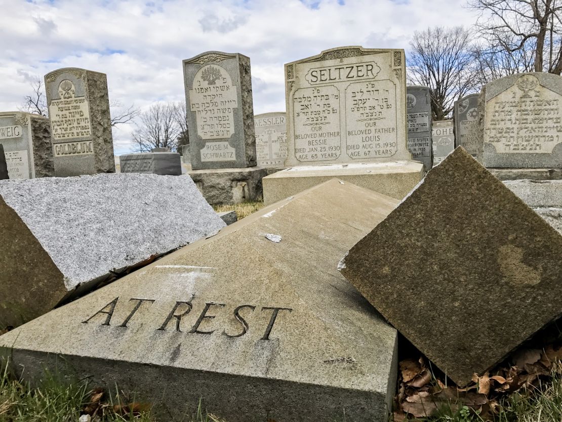 A headstone lies broken in two after vandalism at Mount Carmel Cemetery.