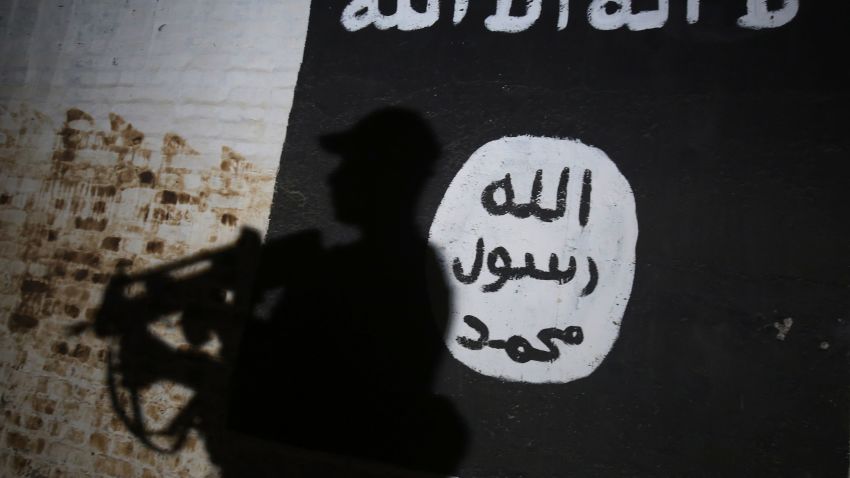 TOPSHOT - A member of the Iraqi forces walks past a mural bearing the logo of the Islamic State (IS) group in a tunnel that was reportedly used as a training centre by the jihadists, on March 1, 2017, in the village of Albu Sayf, on the southern outskirts of Mosul.
Iraqi forces launched a major push on February 19 to recapture the west of Mosul from the Islamic State jihadist group, retaking the airport and then advancing north. / AFP PHOTO / AHMAD AL-RUBAYE        (Photo credit should read AHMAD AL-RUBAYE/AFP/Getty Images)