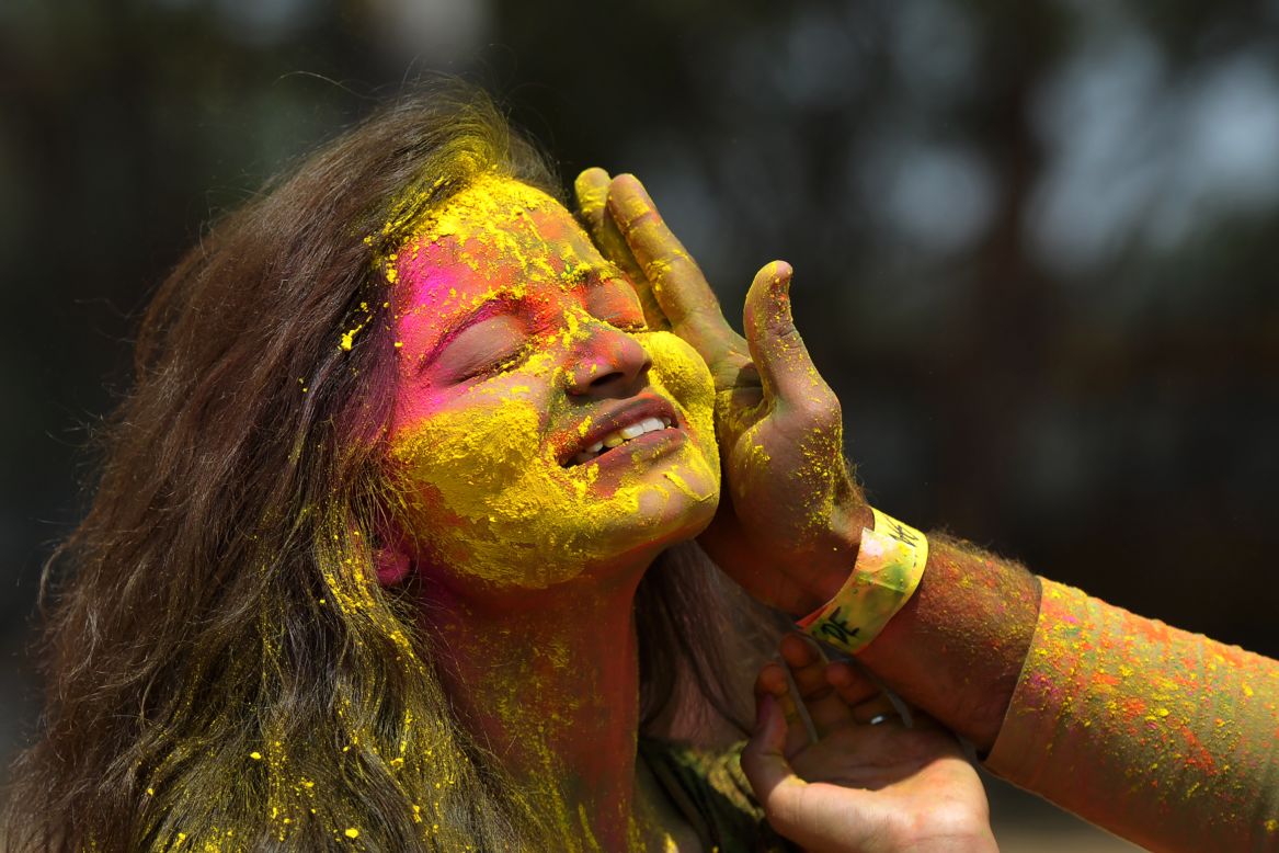 Revelers play with colors during a Holi celebration in Hyderabad, India, on Monday, March 13.