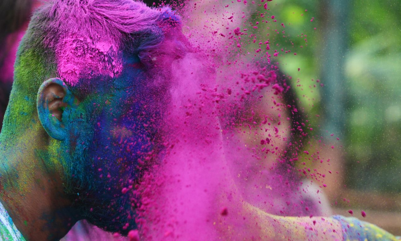 Students play with colored powder in Kolkata on Sunday, March 12.