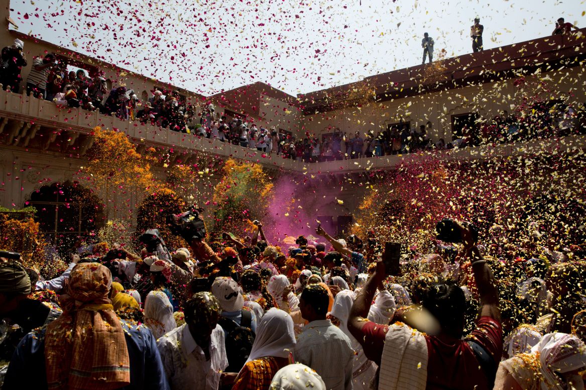 Flower petals and colored powder are thrown at a temple in Vrindavan on Thursday, March 9.