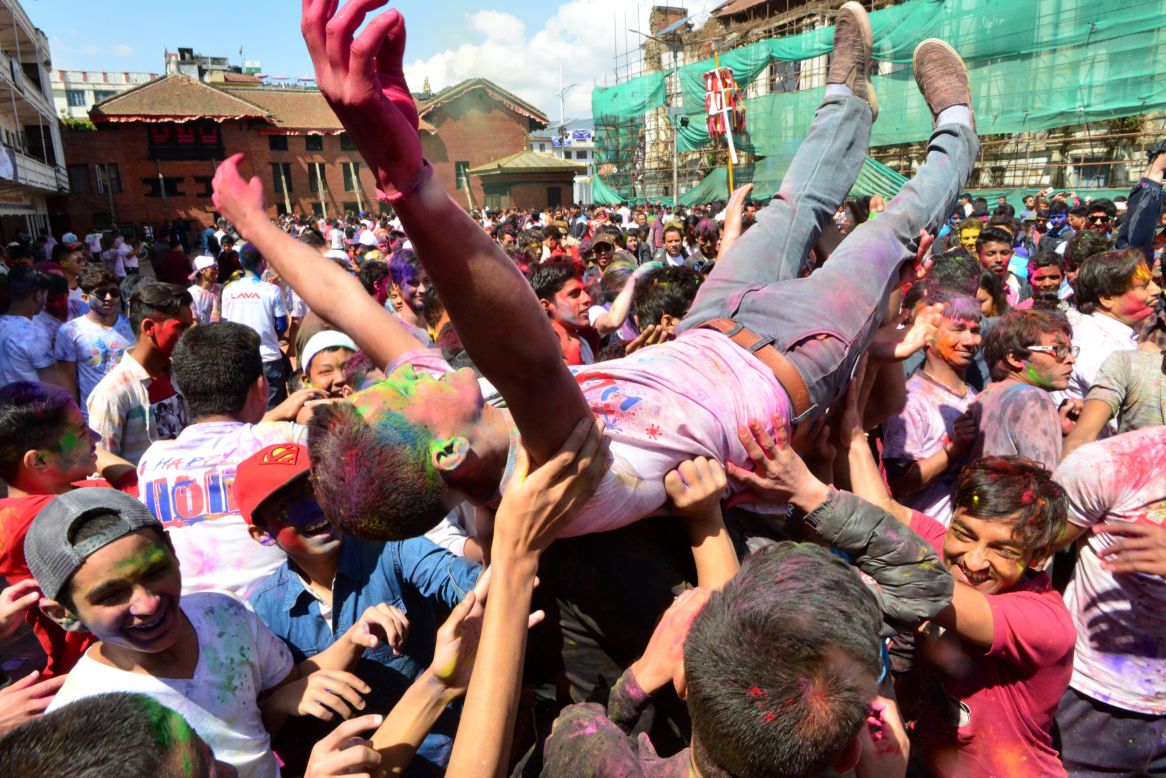 A reveler is tossed into the air in Kathmandu, Nepal, on Sunday, March 12.