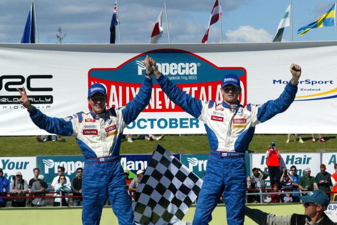 Marcus Gronholm (right) and co-driver Timo Rautiainen celebrate winning the 2002 World Rally Championship following the final stage of the Rally of New Zealand.