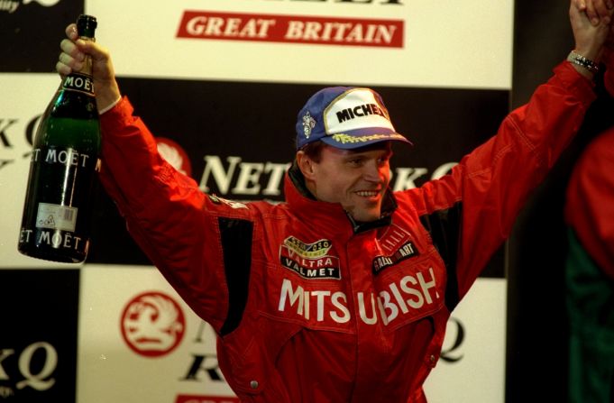 Makinen celebrates being crowned world rally champion in 1998.