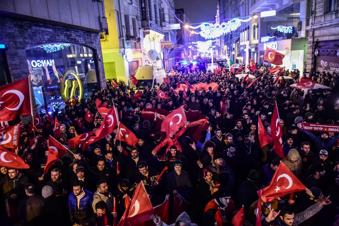 Protestors wave Turkish flags outside the Dutch consulate in Istanbul, March 11.