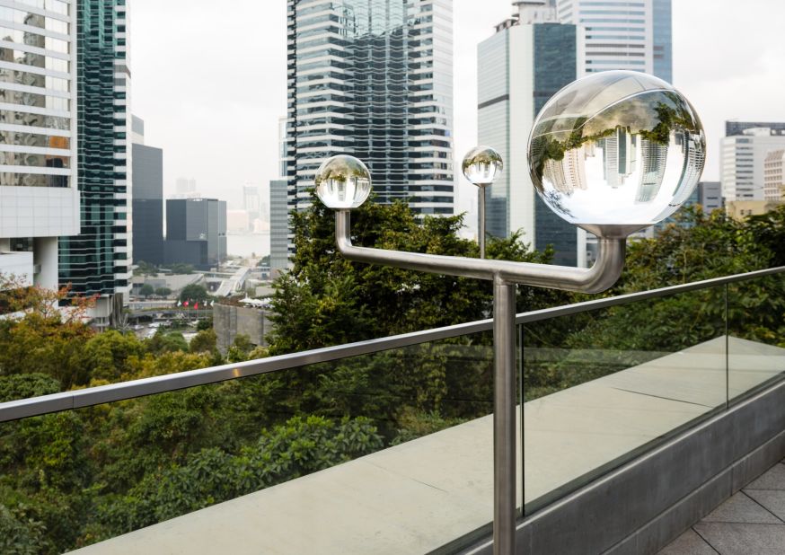 Chloe Cheuk's outdoor sculpture creates a lens-like device from three crystal balls, capable of being swiveled and rearranged to distort and flip different parts of the city skyline. One can swing the contraption toward the harbor — or toward Hong Kong's government building itself.