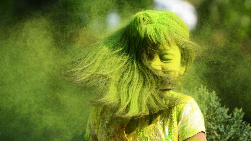 Indian students play with coloured powders as they celebrate 'holi' or the 'festival of colours' during a special function in Kolkata on March 12, 2017. / AFP PHOTO / Dibyangshu SARKAR        (Photo credit should read DIBYANGSHU SARKAR/AFP/Getty Images)