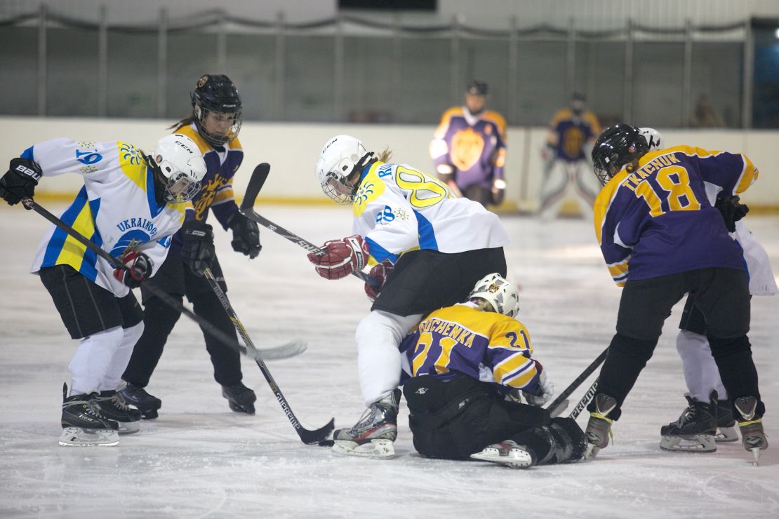 Dnipro Queens and Kyiv Ukrainochka players wrestle for possession during the final.