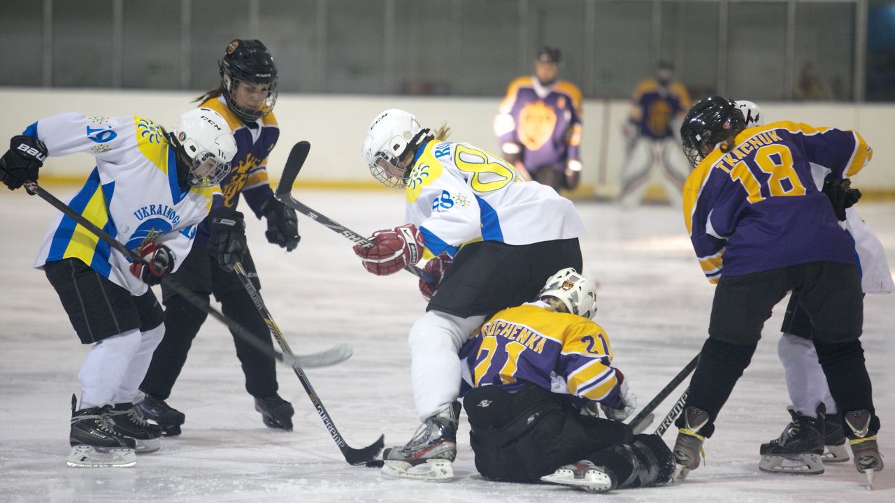 Dnipro Queens and Kyiv Ukrainochka players wrestle for possession during the final.