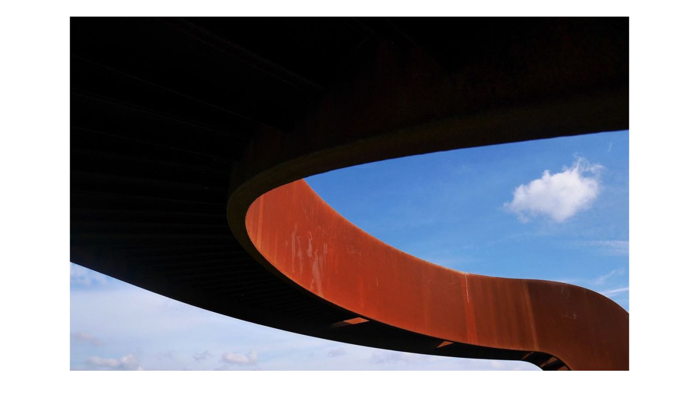 Third Place was awarded to this shot by Urban Poetry. "The curved corten bridge is a great find and the composition is on point. I love that little white cloud in the first third of the photo."