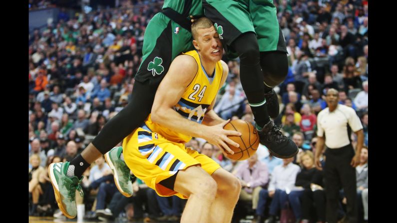 Denver center Mason Plumlee is fouled during an NBA game against Boston on Friday, March 10.