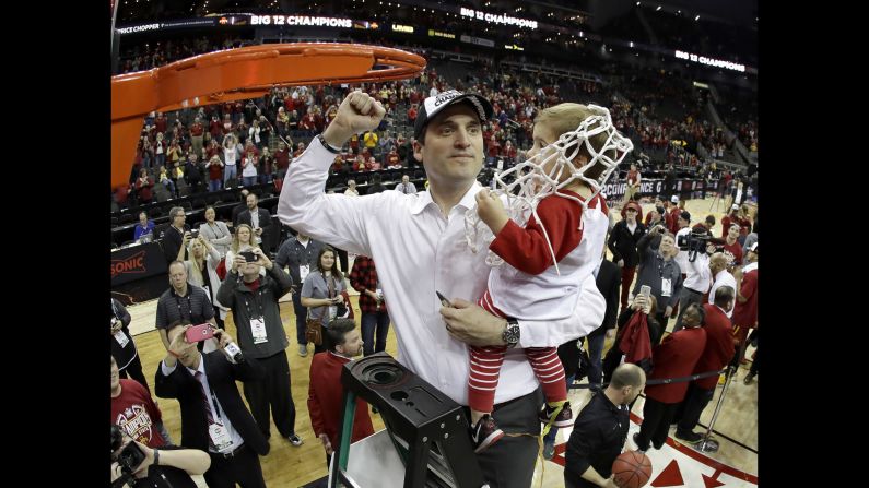 Iowa State head coach Steve Prohm holds his 2-year-old son, Cass, while cutting down the nets at the Big 12 Tournament on Saturday, March 11. Iowa State defeated West Virginia 80-74 in the final.