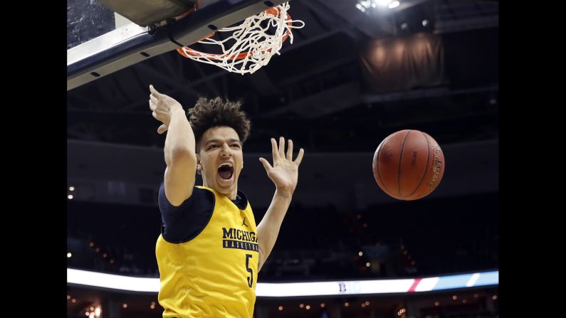 Michigan forward D.J. Wilson dunks the ball during a Big Ten tournament game against Illinois on Thursday, March 9. The Wolverines had to play in their practice jerseys because <a href="index.php?page=&url=http%3A%2F%2Fwww.freep.com%2Fstory%2Fnews%2Flocal%2Fmichigan%2F2017%2F03%2F08%2Funiversity-michigan-basketball-plane-crash%2F98914844%2F" target="_blank" target="_blank">of a plane crash</a> one day earlier. No one was hurt when the team plane skidded off the runway after an aborted takeoff, but the uniforms had to be left on the plane while authorities investigated the scene. Michigan went on to win four games in four days, defeating Wisconsin in the tournament final.<br />