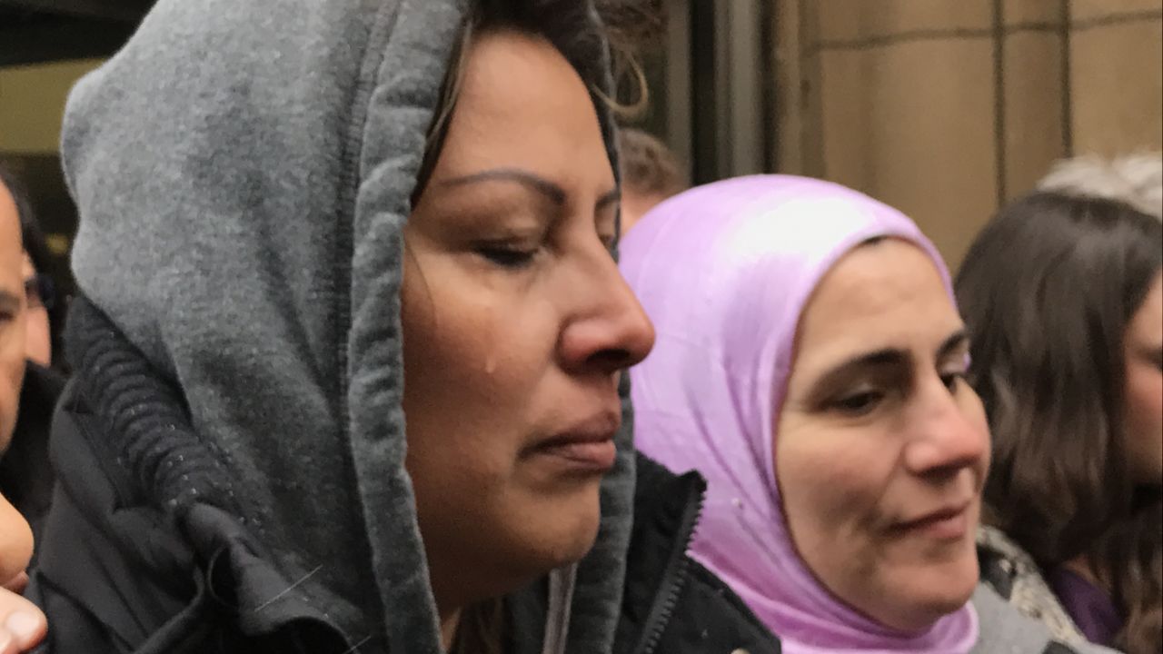 Francisca Lino sheds tears outside ICE headquarters in Chicago.