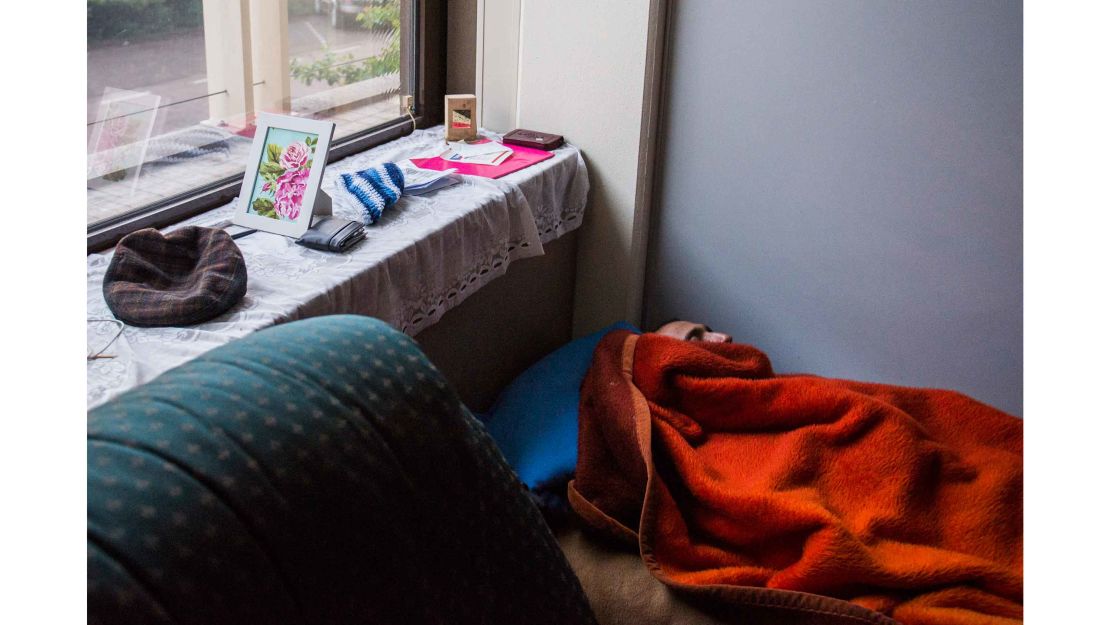 An asylum-seeker sleeps on a makeshift bed at a building squatted by We Are Here members in Amsterdam, in May 2015.