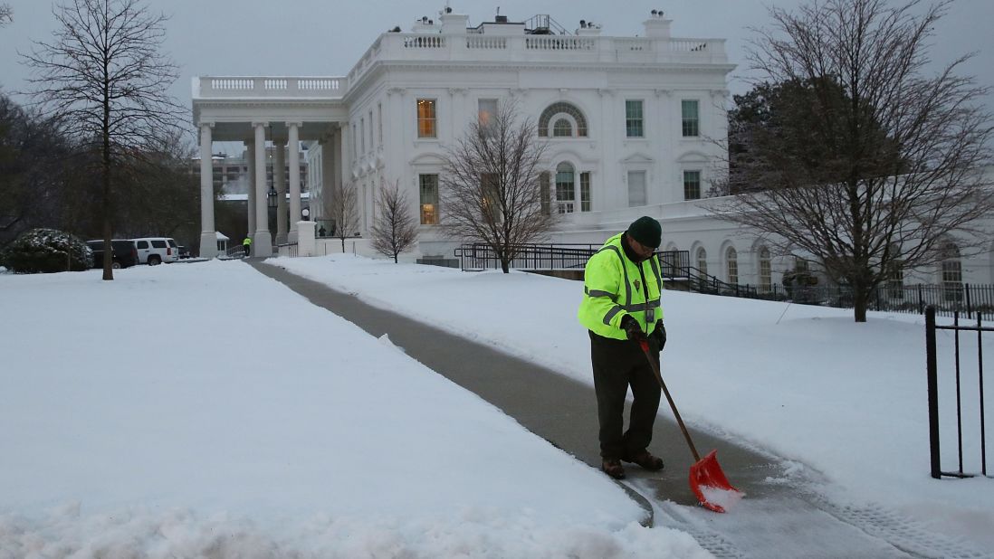 A National Park Service employee shovels snow at the White House on March 14.
