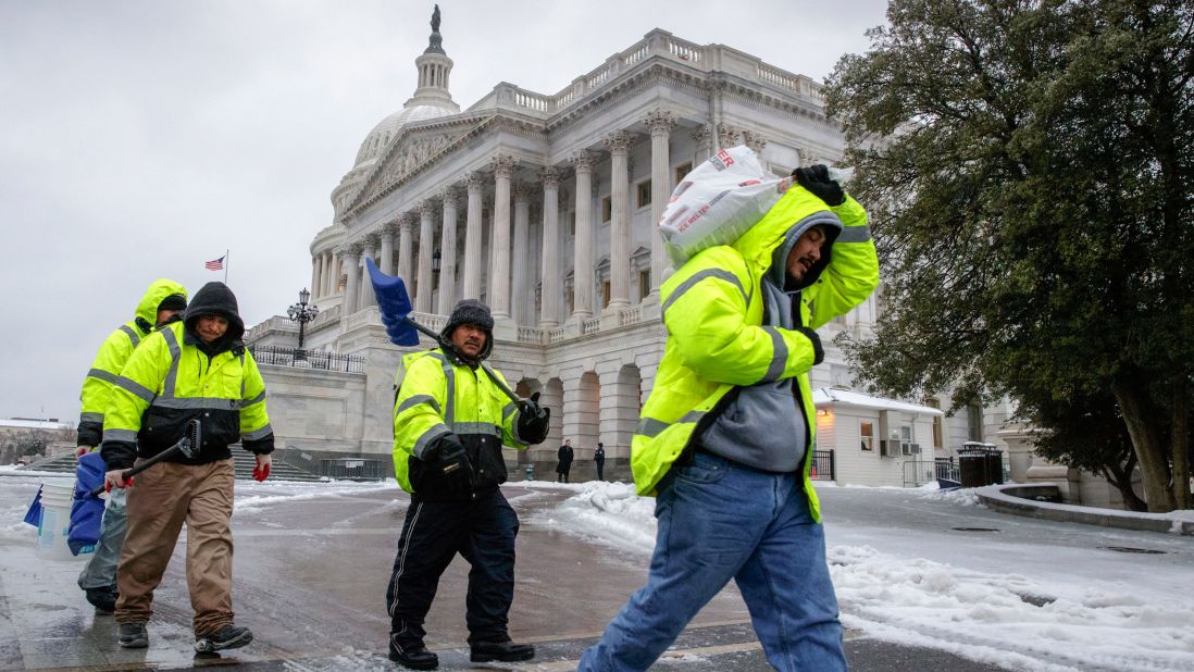 Workers in Washington clear snow on Capitol Hill on March 14.