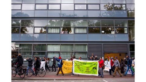 On the day they are evicted from the Vluchtgebouw, We Are Here members march through Amsterdam to demonstrate against the treatment of asylum-seekers. Their banner depicts Dutch PM Mark Rutte saying 'I don't respect human dignity.'