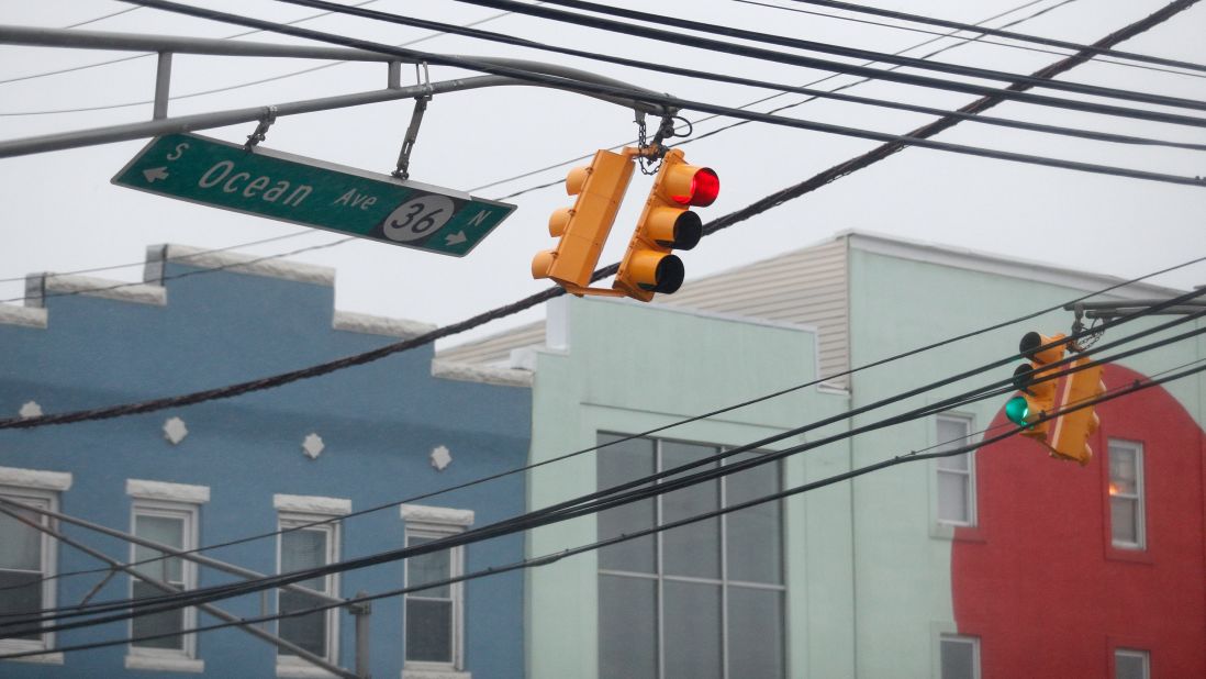 Traffic lights and a street sign sway in heavy winds in Sea Bright, New Jersey, on March 14.