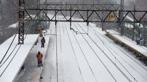 Metro North employees clear the snow off the platform at the Greenwich Station in Greenwich, Connecticut, on March 14.
