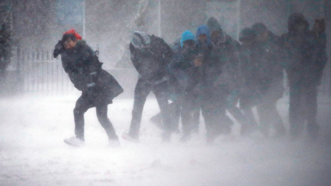 People struggle to walk in Boston on March 14.