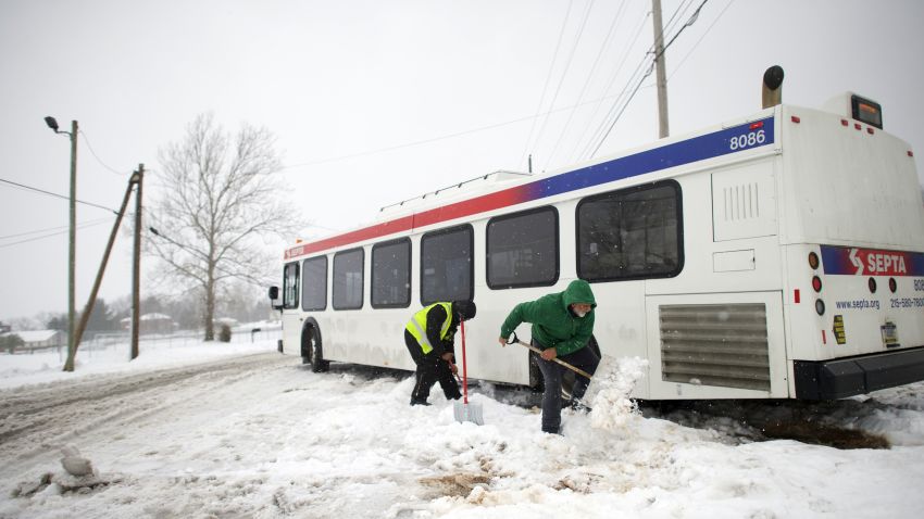 Blaine Webb helps a SEPTA employee shovel out a bus from the snow March 14, 2017 in Spring City, Pennsylvania.  