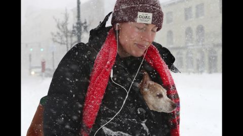 Taryn Hallweaver and her dog, Willy, walk in Portland, Maine, on March 14.
