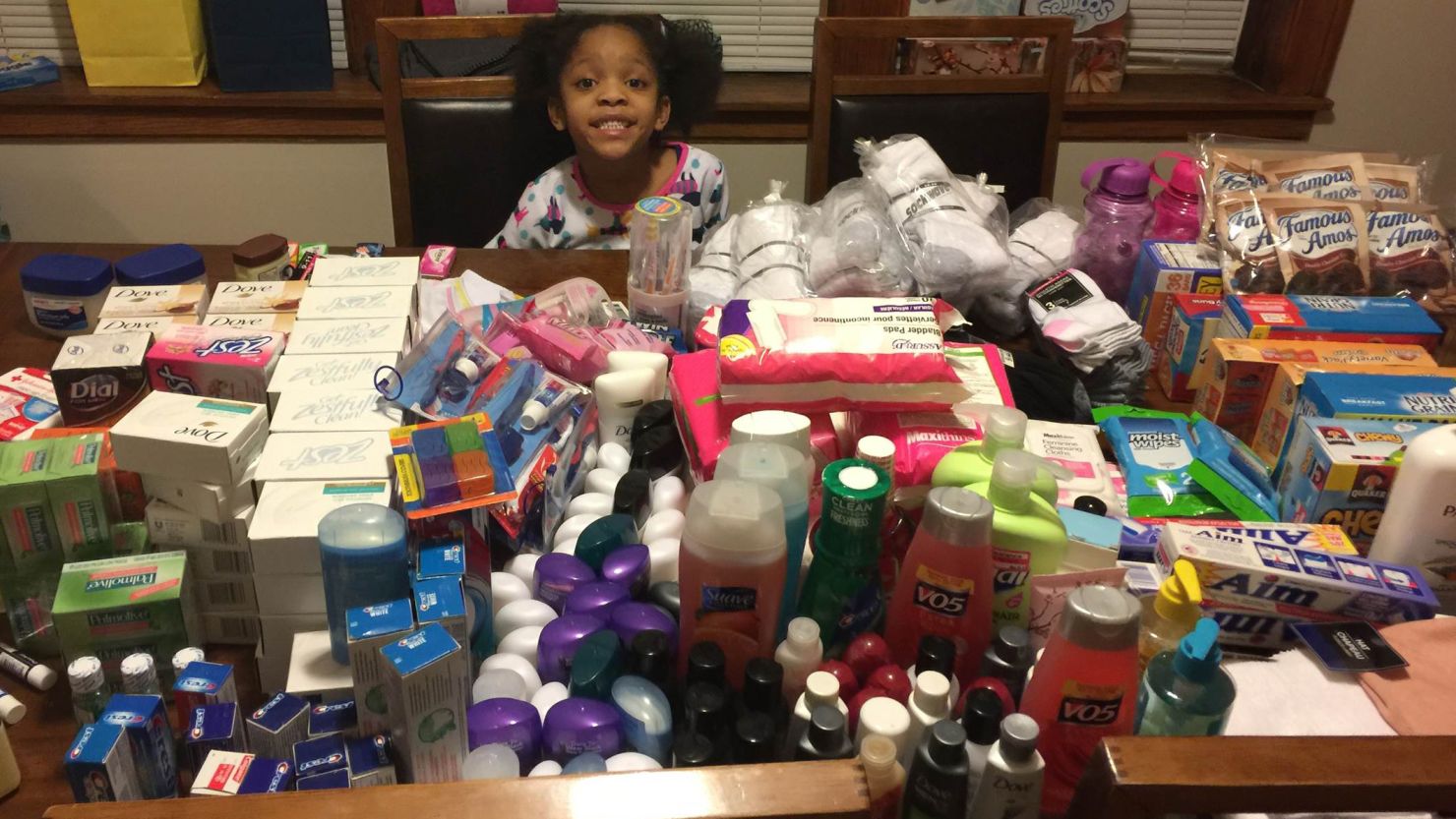 Armani Crews prepares care packages with donated toiletries for a food drive for the homeless on her 6th birthday.