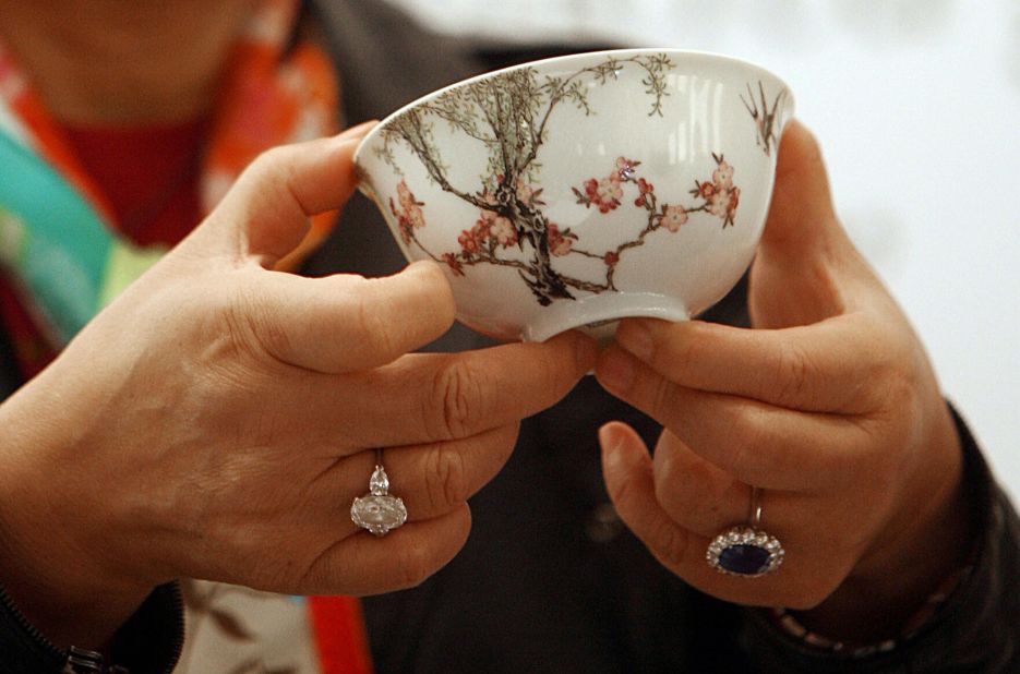 Chinese ceramics collector Alice Cheng holds an 18th century Chinese famille-rose "swallows bowl" she purchased at a Christie's auction in Hong Kong in 2006. The tiny bowl sold for $19.4 million (HK$151.3 million), breaking the record at that time for a piece of Chinese ceramic art at auction. 