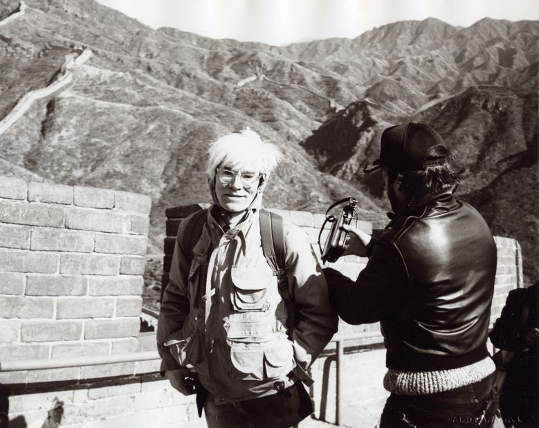 Warhol visited the Great Wall of China during his three-day trip to Beijing. According to photographer Christopher Makos, who accompanied Warhol on the trip, the man in the leather jacket is probably documentary maker Lee Caplin.