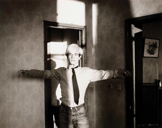 Here Warhol is mimicking a Tai Chi pose, likely in Beijing's Peking Hotel. The late pop artist allegedly wore the same outfit every day during the trip.