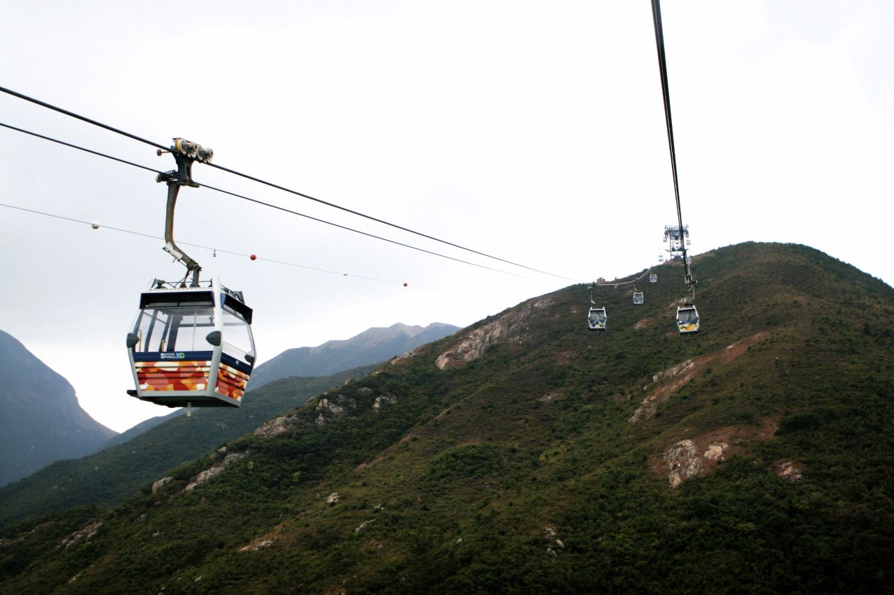 Views of hills, houses and ocean from Ngong Ping cable car.