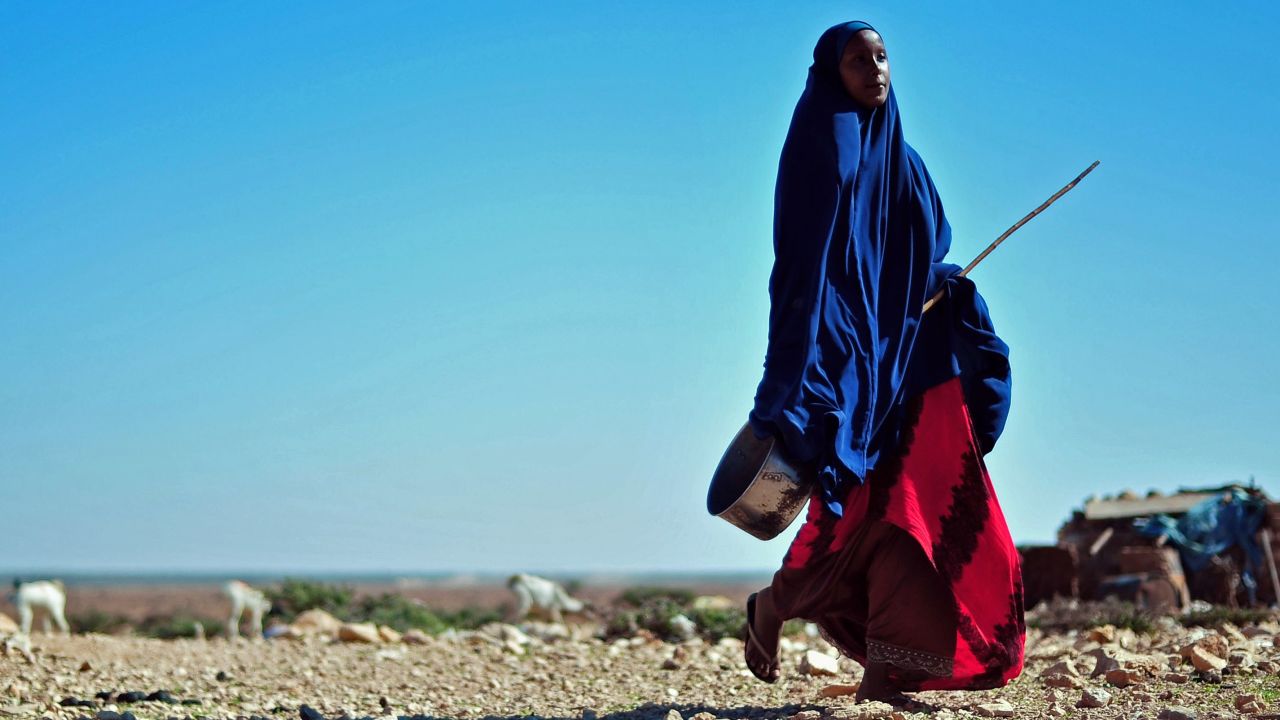  A woman walks through a parched area in northeastern Somalia earlier this year. Rape is on the rise there.
