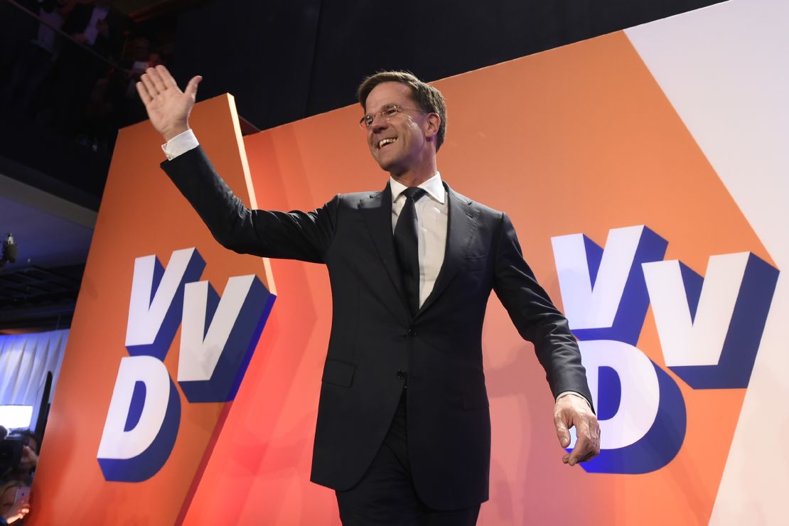 Netherlands' Prime Minister Mark Rutte celebrates after exit polls put him in first place.
