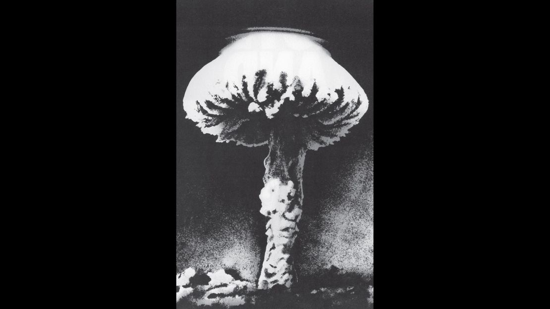 An image of a mushroom cloud from a nuclear explosion printed in the original booklet.