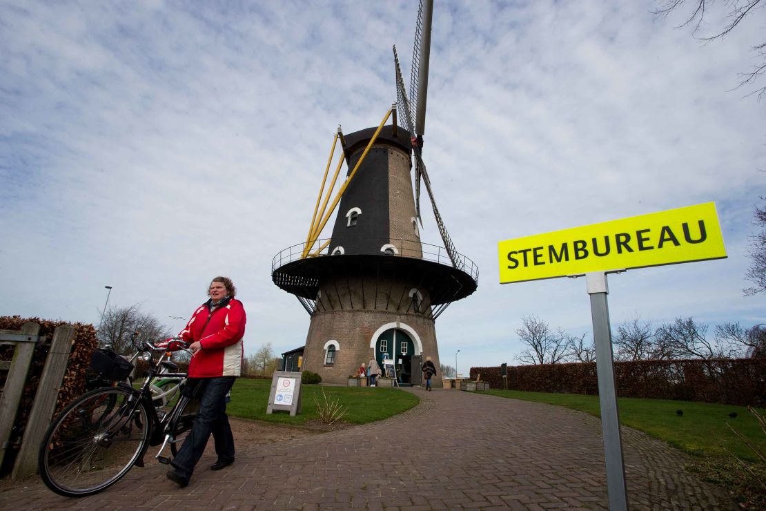 A woman leaves after casting her vote at a windmill turned polling station in Oisterwijk, south central Netherlands on Wednesday.