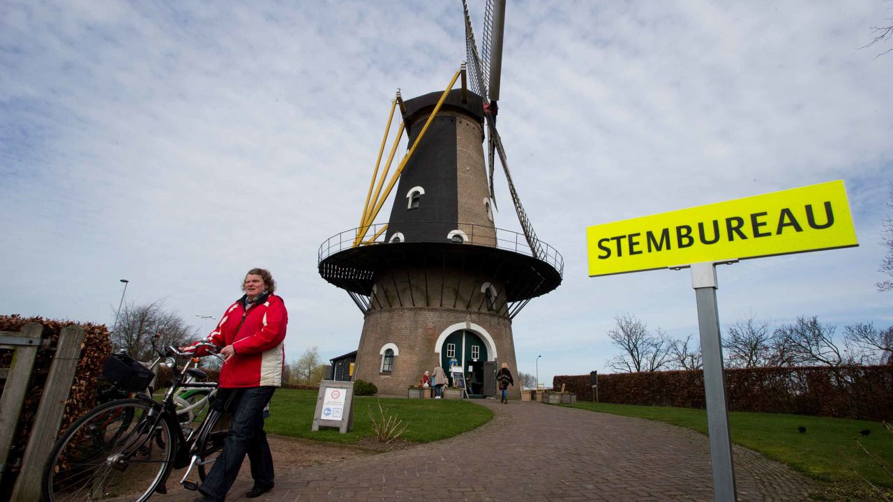 A woman leaves after casting her vote at a windmill turned polling station in Oisterwijk, south central Netherlands on Wednesday.