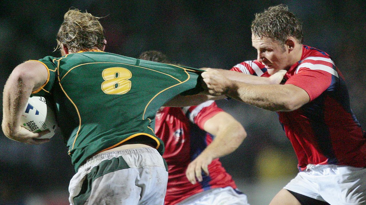 Dan Payne (R) tackles South Africa's Schalk Burger during a match at the 2007 Rugby World Cup.