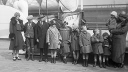 (Original Caption) 3/16/1926-New York-Photo shows Mrs. Thomas McKessy, of Limerick, Ireland, upon her arrival in New York on the SS Aurania. She is joining her husband, who came over last September, with 10 of her family of 21 children. Pictured (L-R) are Johanna, John, Dennis, Lizzie, Katherine, Bridget, Eugene, Donald, Ita, and Mrs. McKessy holding Cecilia the youngest in her arms. Of her 21 children, 4 are here already, 10 just arrived, 5 died and two are married in Ireland.