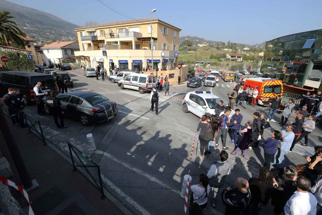 People stand outside a police security cordon near the  Alexis de Tocqueville high school in Grasse on Thursday.