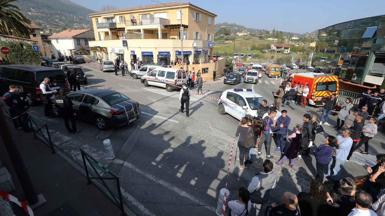 People stand outside a police security cordon near the  Alexis de Tocqueville high school in Grasse on Thursday.
