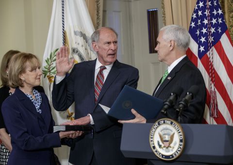 Vice President Mike Pence, right, administers the oath of office to Dan Coats, the new director of national intelligence, on Thursday, March 16. Coats was accompanied by his wife, Marsha. He was confirmed by the Senate the day before.