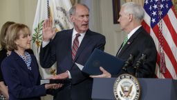 Vice President Mike Pence administers the oath of office to Director of National Intelligence Dan Coats, accompanied by his wife Marsha Coats, Thursday, March, 16, 2017, on Capitol Hill in Washington,  (AP Photo/J. Scott Applewhite)